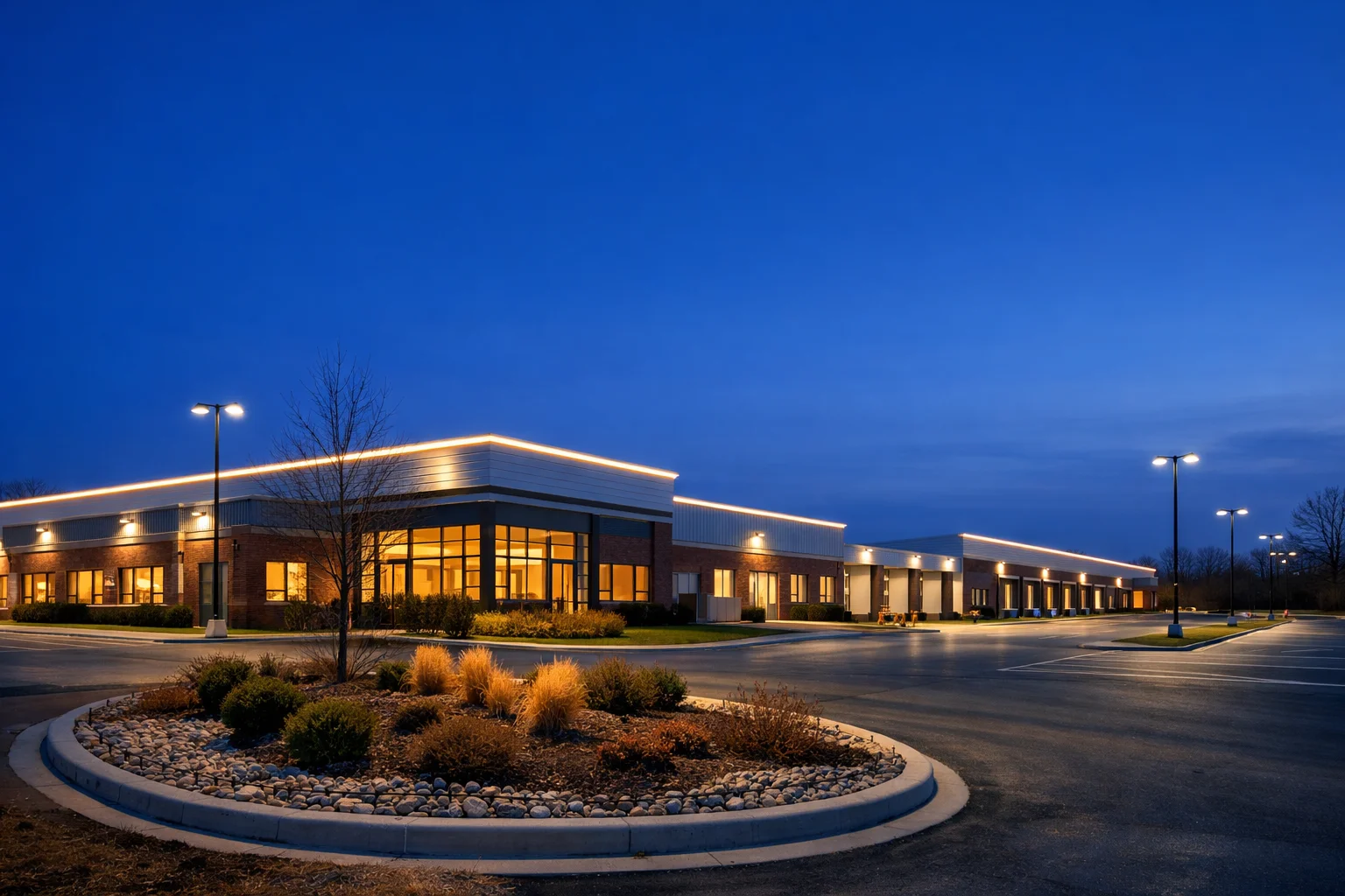 Illuminated industrial office park at blue hour along the Columbus, Indiana commercial corridor