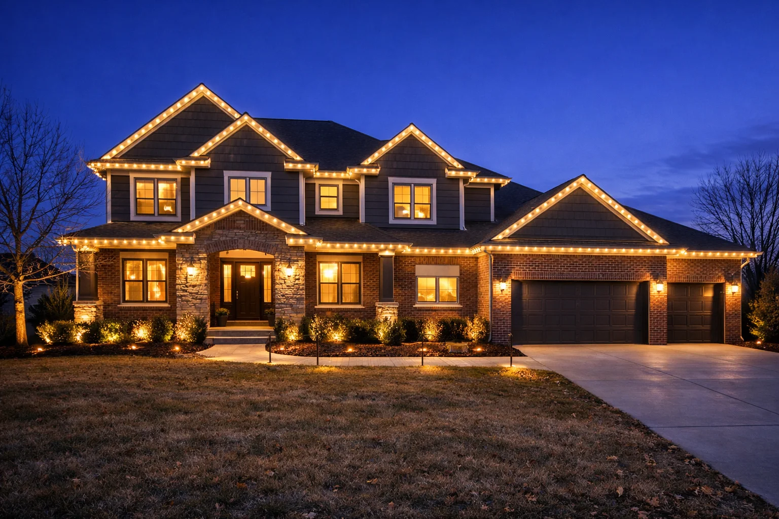 Indiana home with warm holiday roofline lighting in winter at twilight
